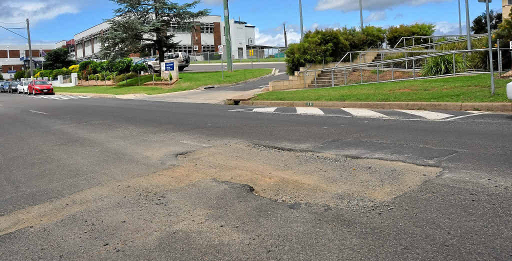 This road damage on Locke St is just one of many areas in need of repair.